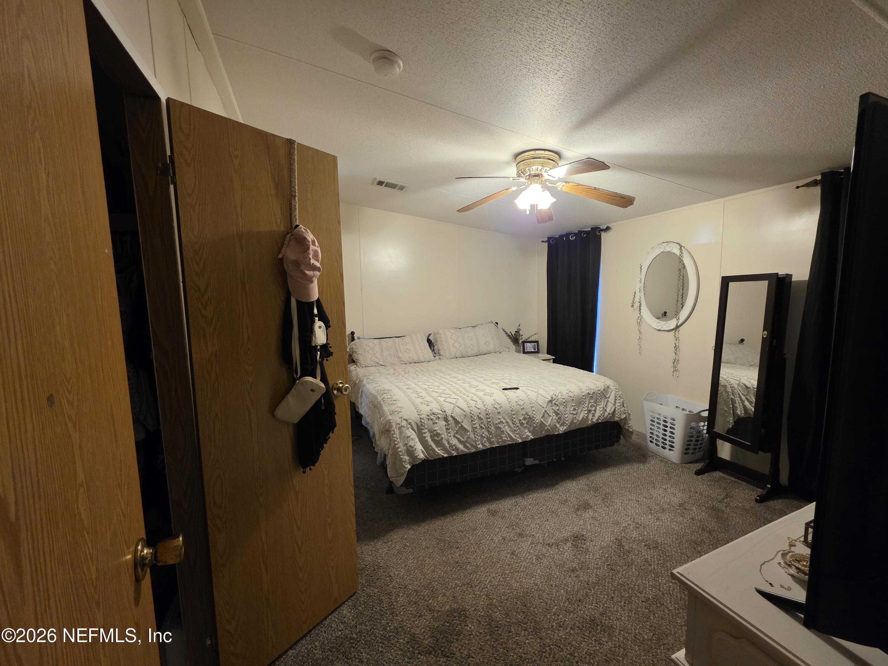 104 Lunker Lodge Road Georgetown, FL 32139 - Photo 13 of 19 a bedroom with a bed and a chandelier