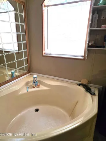 a bath tub sitting next to a window