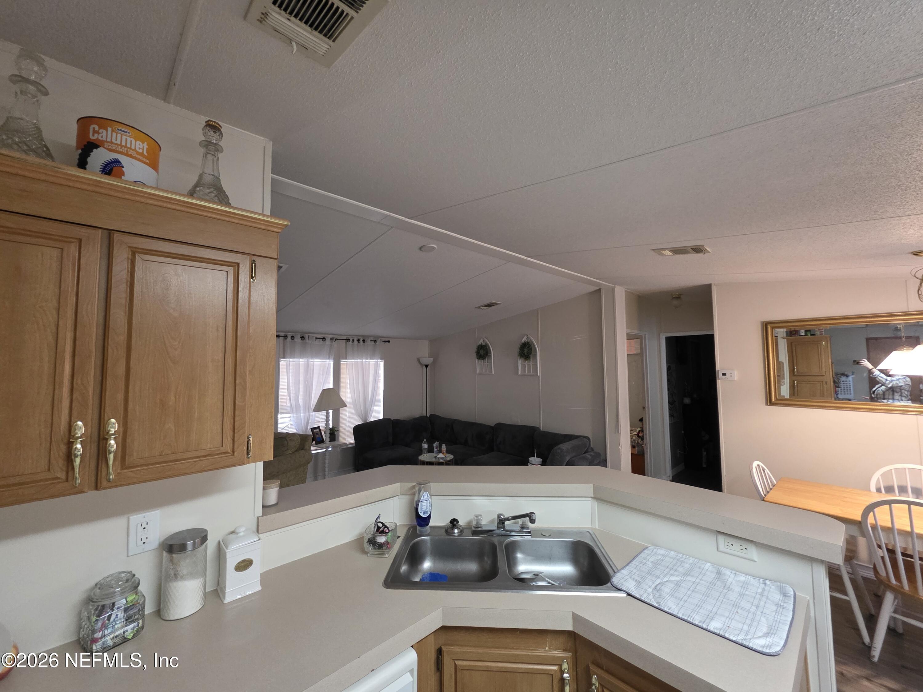 104 Lunker Lodge Road Georgetown, FL 32139 - Photo 8 of 19 a kitchen with a refrigerator and a stove top oven
