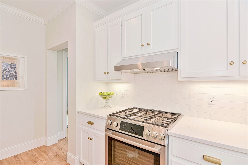 9 Damon Road, Unit 15 Needham Heights, MA 02494 - Photo 4 of 18 a kitchen with white cabinets and appliances