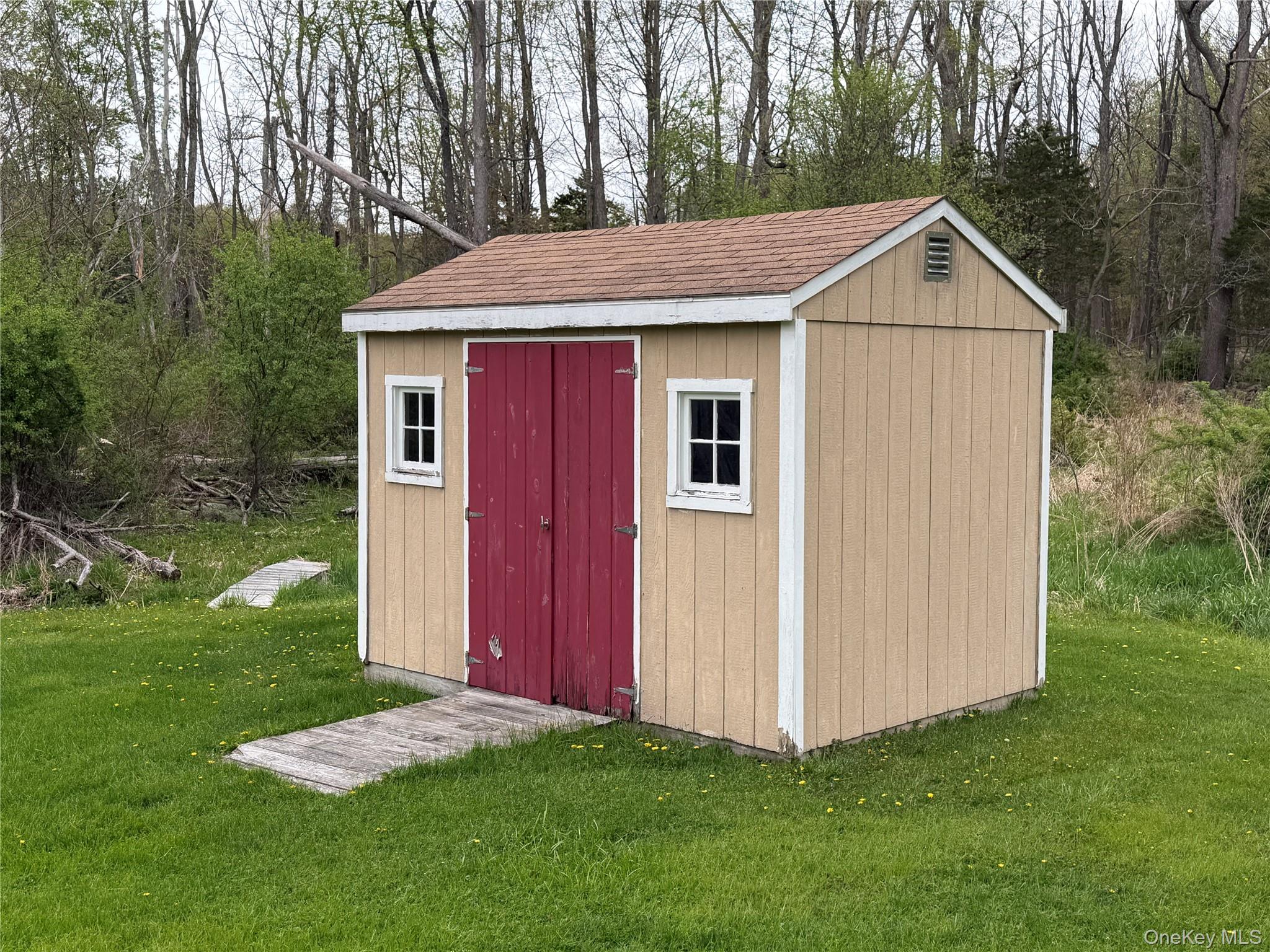 94 Booth Road Chester, NY 10918 - Photo 19 of 21 Freestanding storage shed featuring tan siding with white trim and a brown shingle roof