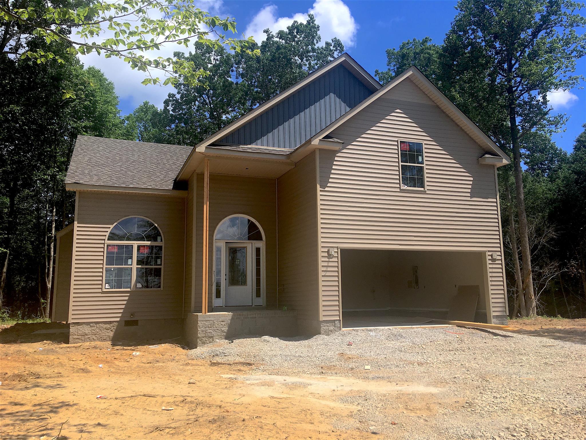 2655 Mockingbird Hill Road Palmyra, TN 37142 - Photo 9 of 22 a front view of a house with a yard