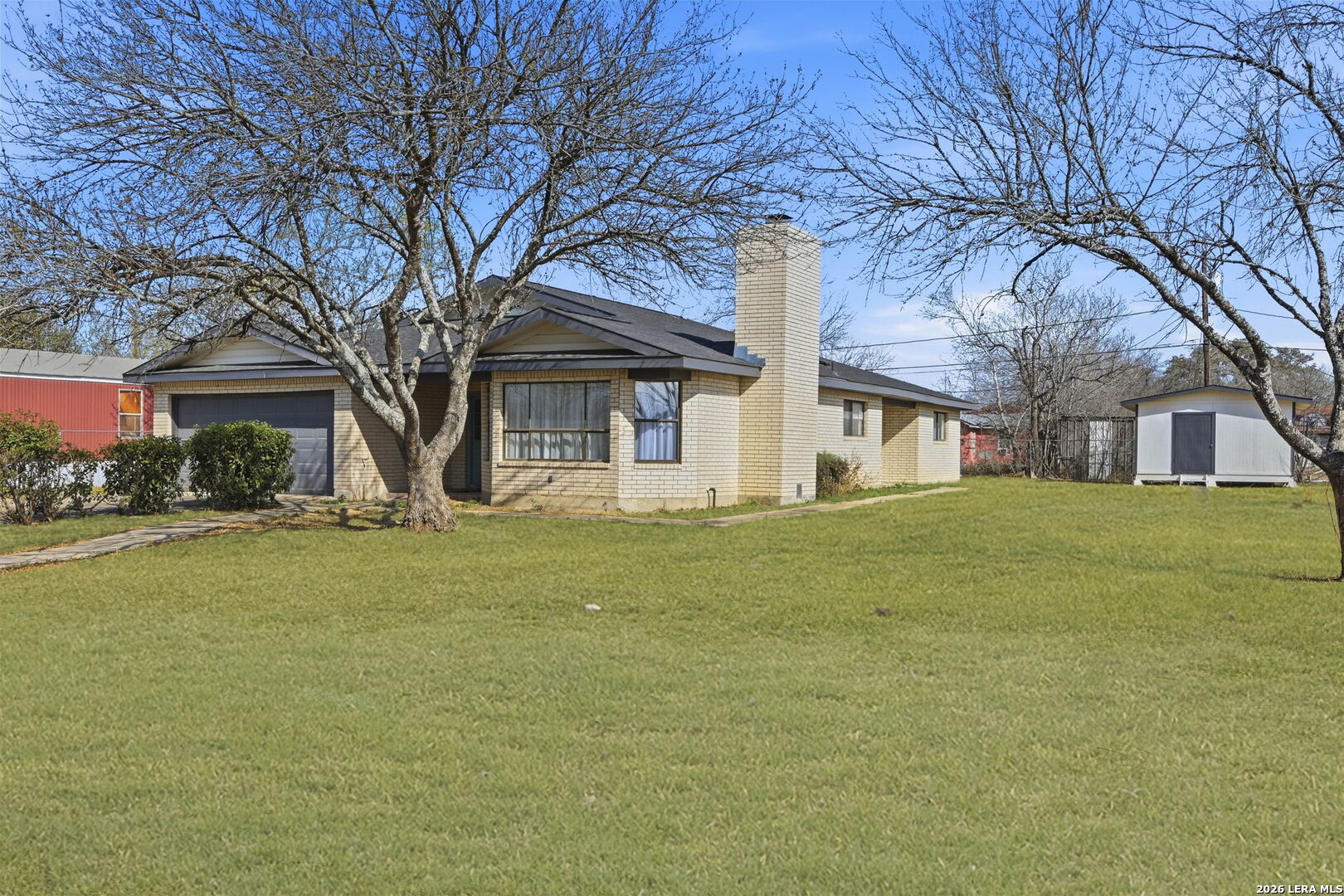 508 Crouch Avenue Devine, TX 78016 - Photo 2 of 26 a front view of a building with a garden