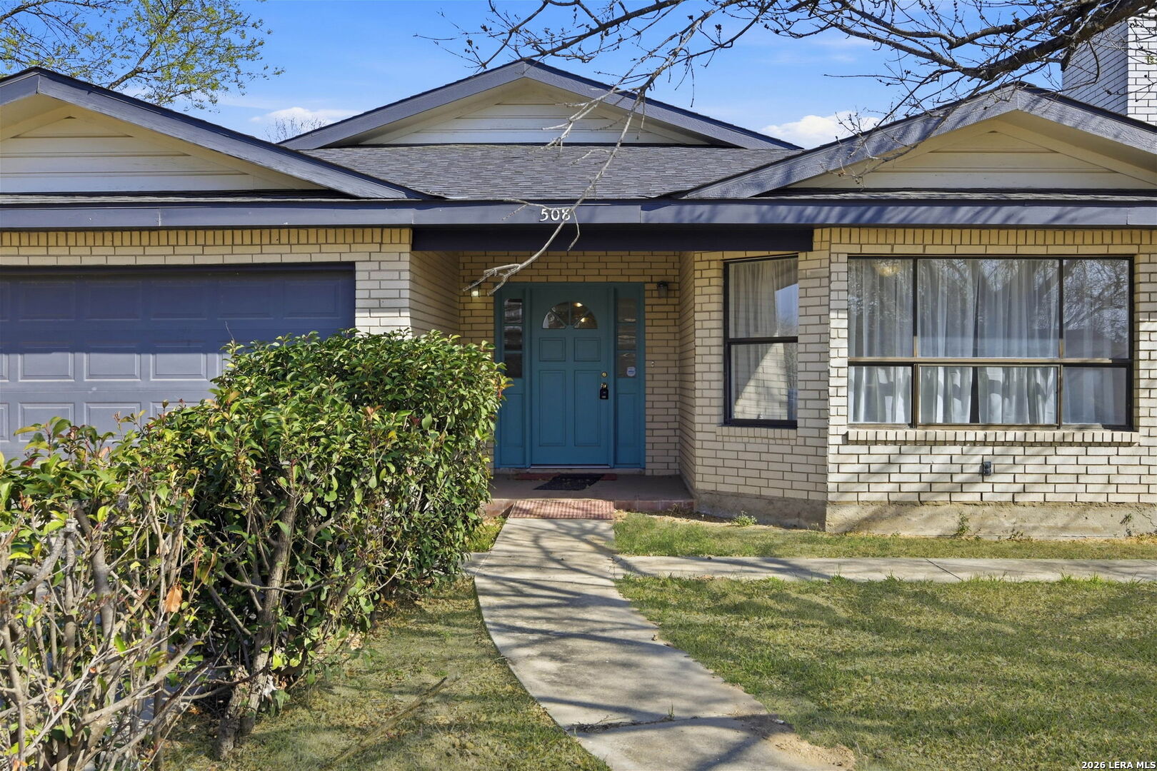 508 Crouch Avenue Devine, TX 78016 - Photo 3 of 26 a front view of a house with garden