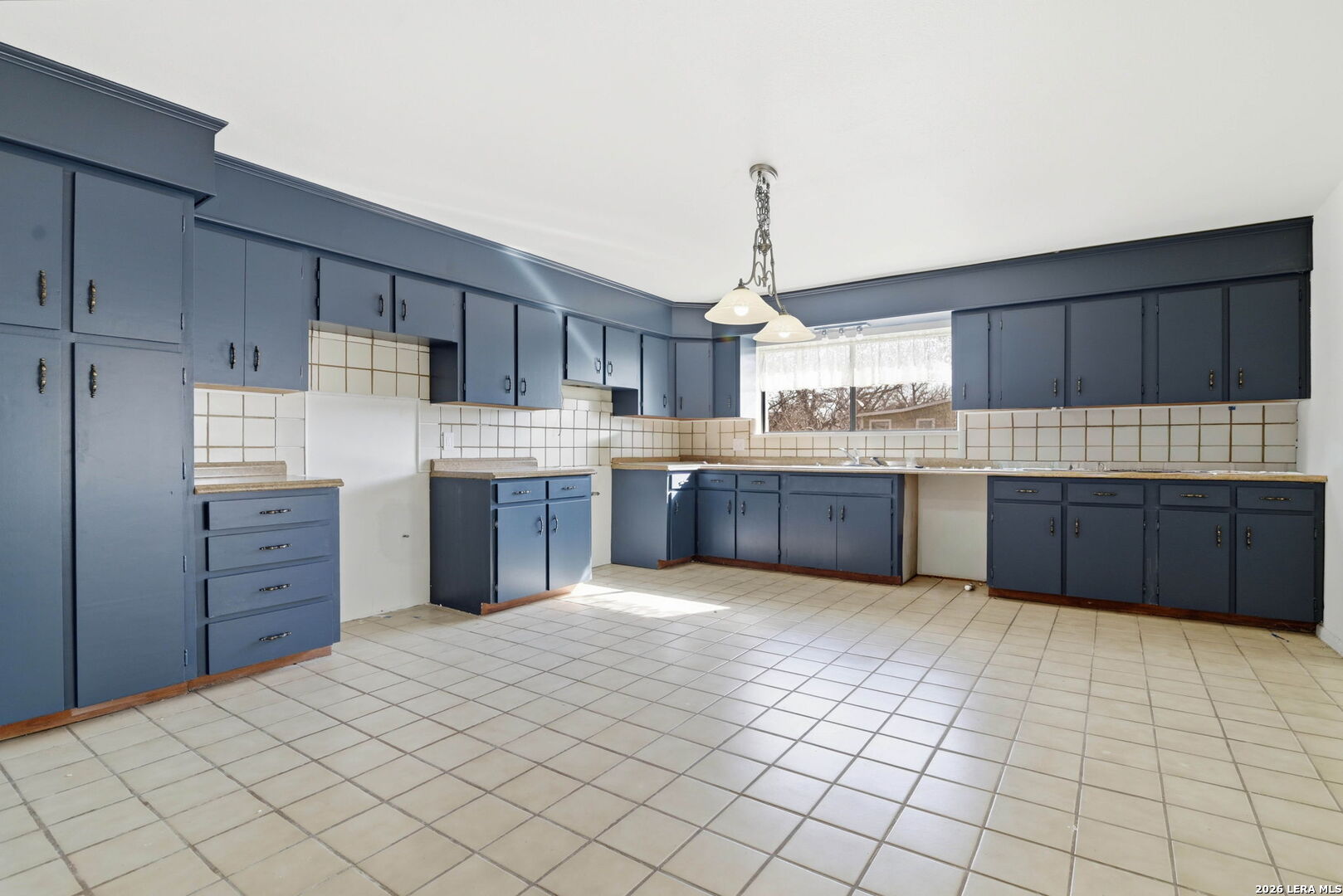508 Crouch Avenue Devine, TX 78016 - Photo 7 of 26 a kitchen with stainless steel appliances granite countertop a sink counter space cabinets and a counter top space