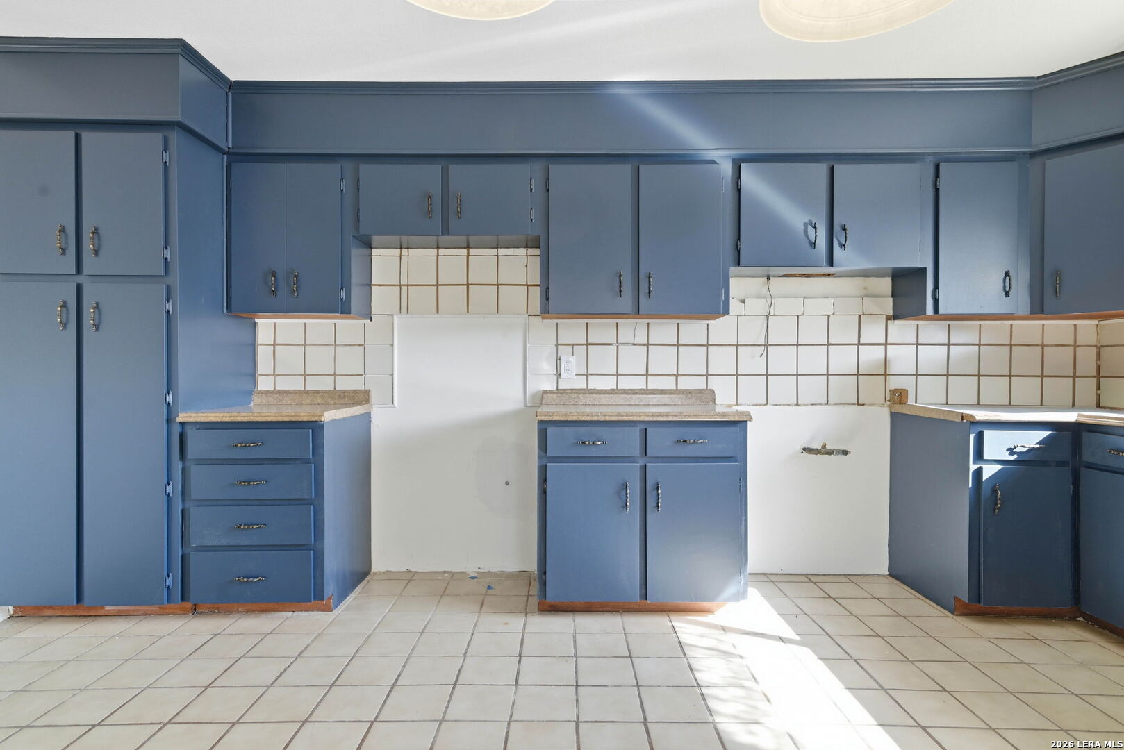508 Crouch Avenue Devine, TX 78016 - Photo 8 of 26 a kitchen with cabinets and window