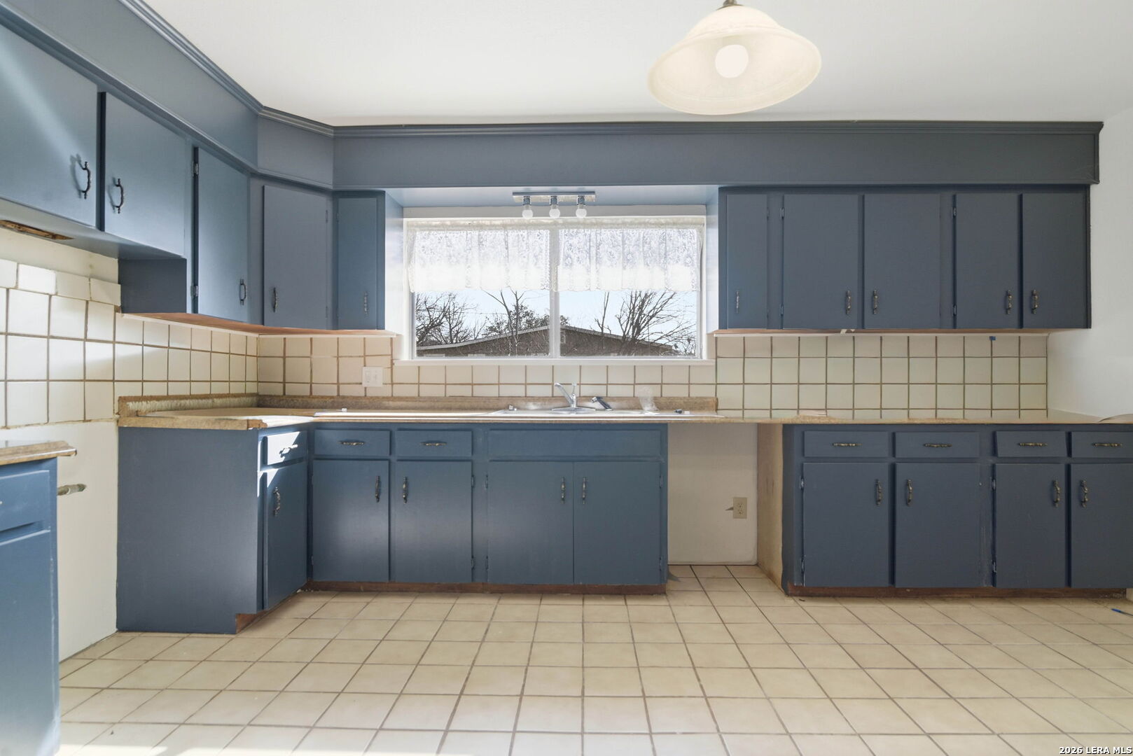 508 Crouch Avenue Devine, TX 78016 - Photo 10 of 26 a kitchen with a cabinets and window