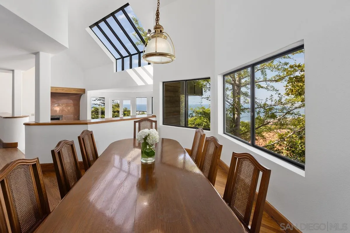 1888 Puente Drive La Jolla, CA 92037 - Photo 11 of 30 a view of a dining room with furniture a livingroom and wooden floor