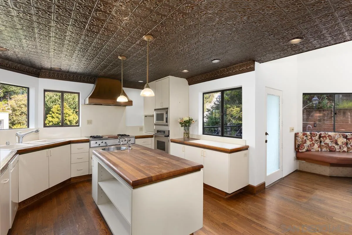 1888 Puente Drive La Jolla, CA 92037 - Photo 13 of 30 a kitchen that has a lot of cabinets in it