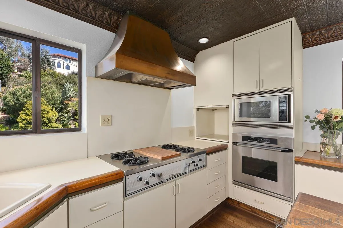 1888 Puente Drive La Jolla, CA 92037 - Photo 14 of 30 a kitchen with stainless steel appliances granite countertop a stove and a refrigerator