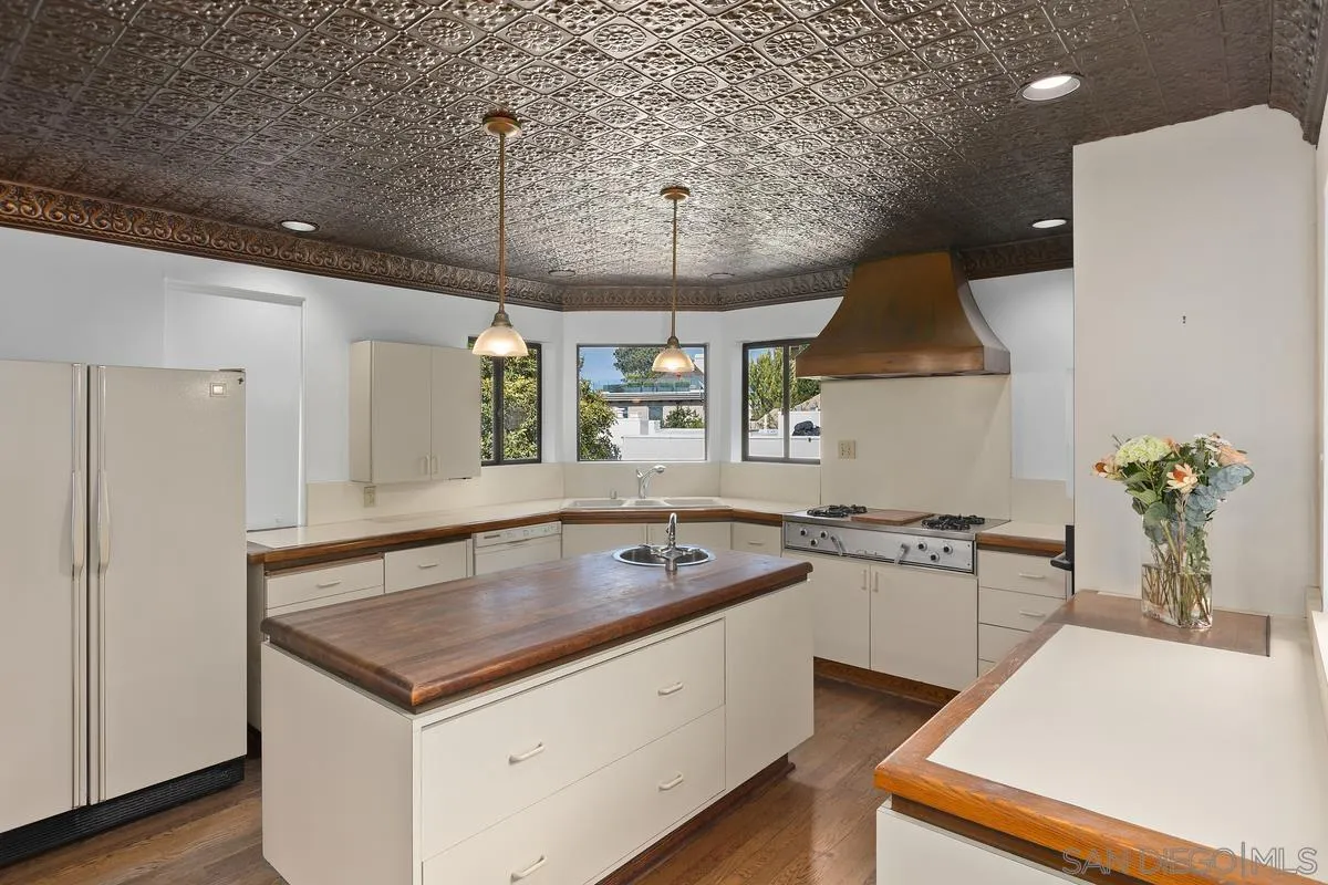 1888 Puente Drive La Jolla, CA 92037 - Photo 15 of 30 a kitchen that has a sink a stove and a table