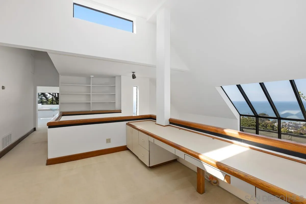 1888 Puente Drive La Jolla, CA 92037 - Photo 22 of 30 a living room with a bed and a window