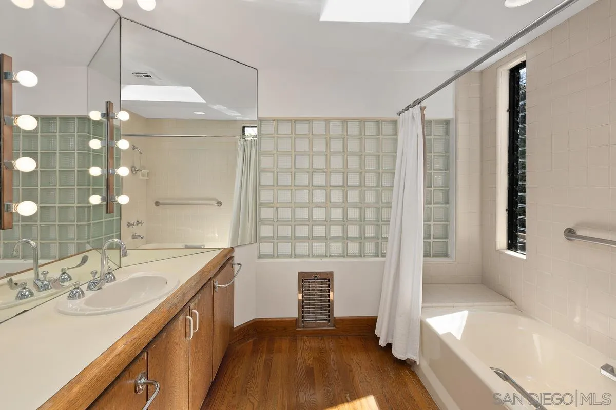 1888 Puente Drive La Jolla, CA 92037 - Photo 28 of 30 a bathroom with a sink a tub and a large mirror