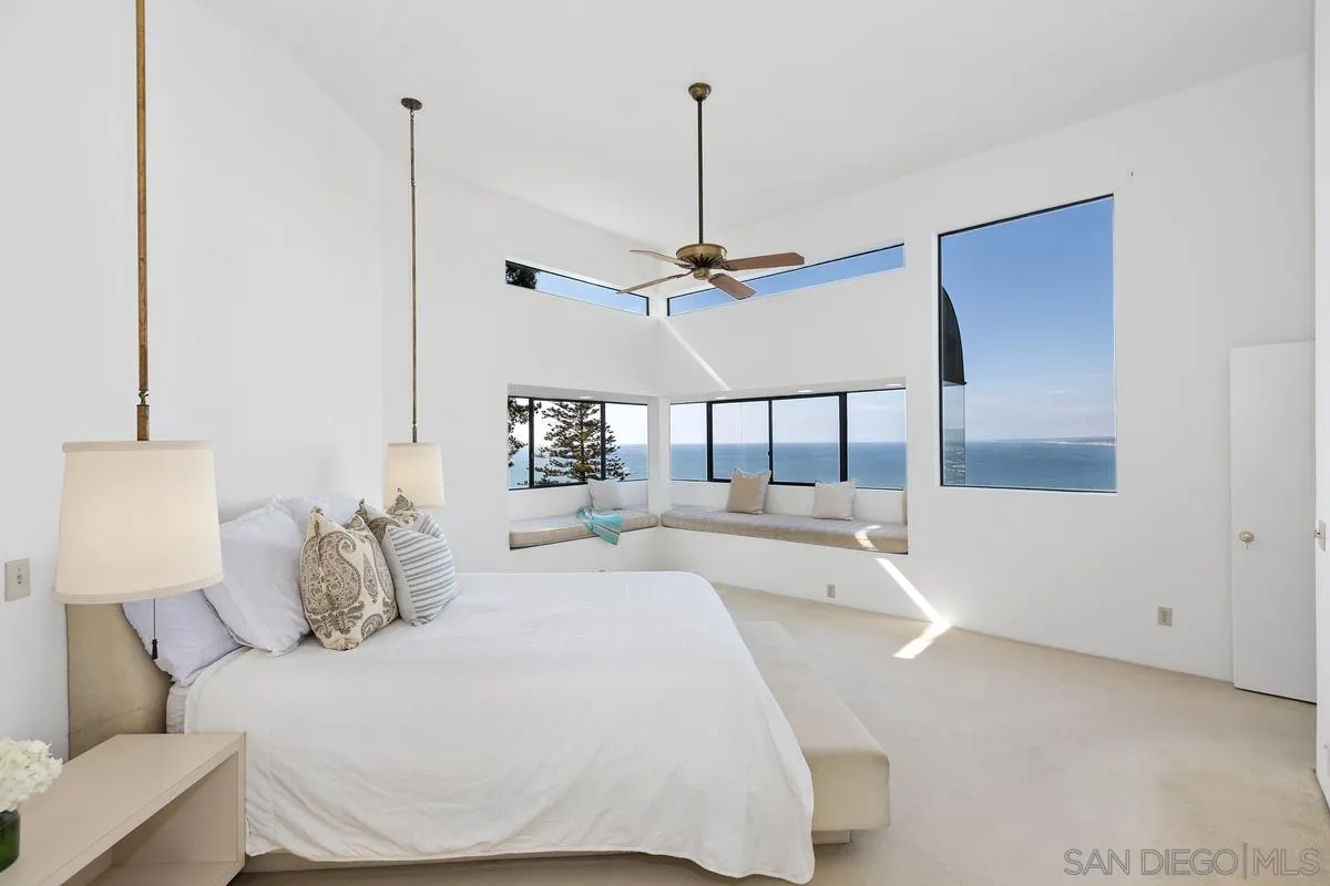 1888 Puente Drive La Jolla, CA 92037 - Photo 7 of 30 a bedroom with a bed and a chandelier