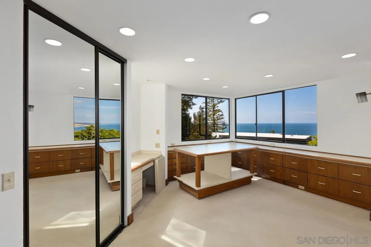 1888 Puente Drive La Jolla, CA 92037 - Photo 9 of 30 a large kitchen with stainless steel appliances a large counter top a stove and a refrigerator