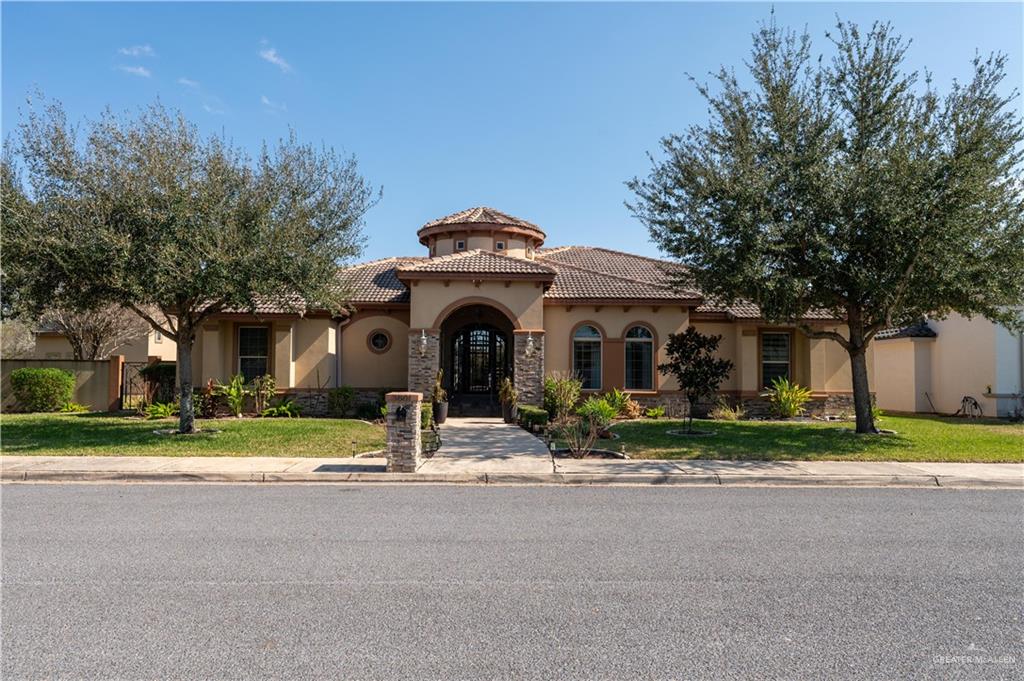 3801 South L Street McAllen, TX 78503 - Photo 1 of 45 a front view of a house with a yard and garage