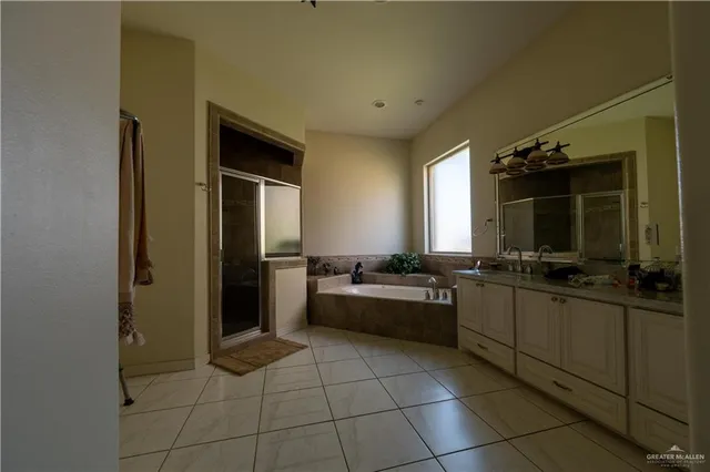 a bathroom with a tub sink and mirror
