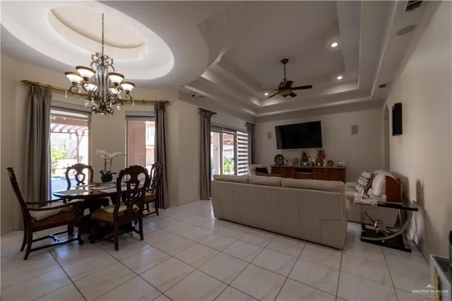 a view of a dining room with furniture and chandelier