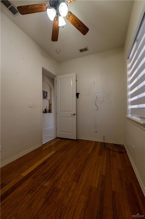 3801 South L Street McAllen, TX 78503 - Photo 37 of 45 an empty room with wooden floor chandelier fan and windows
