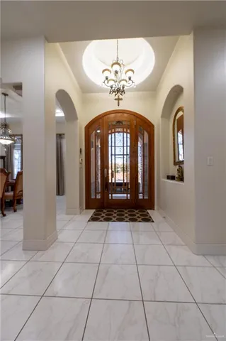 a lobby with furniture and a chandelier