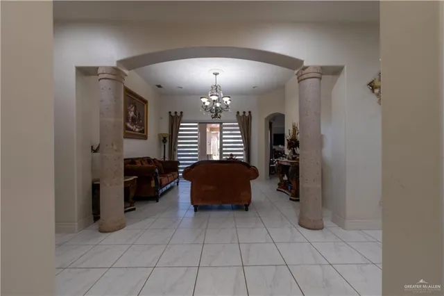 a living room with furniture chandelier and a window