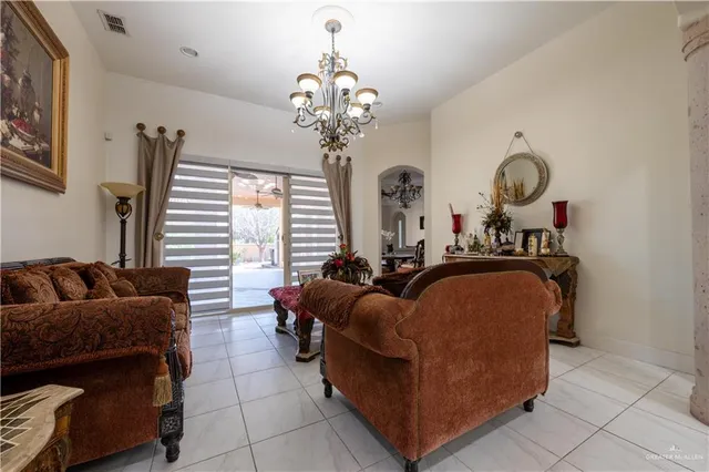 a living room with furniture chandelier and a chandelier