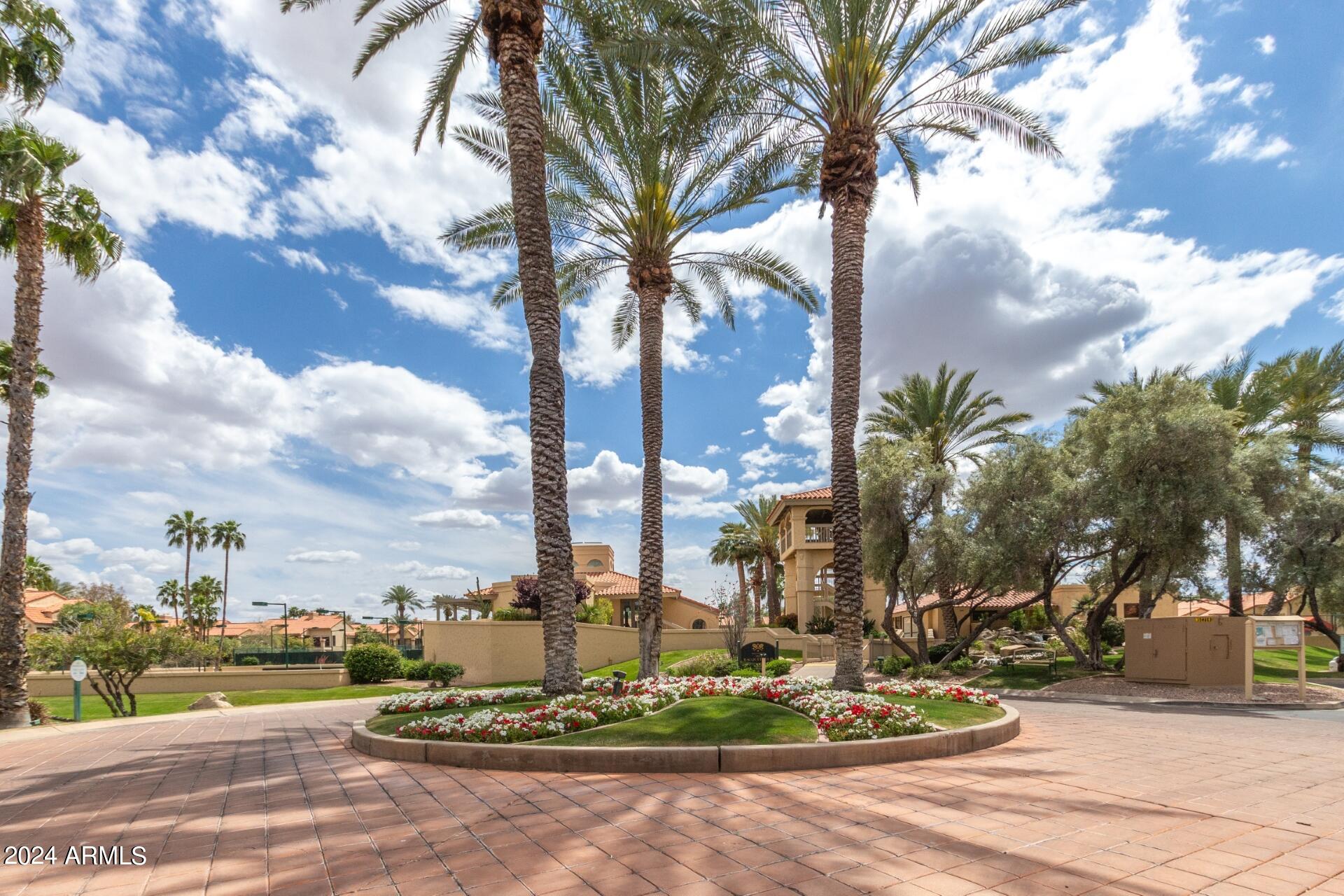 9705 East Mountain View Road, Unit 1036 Scottsdale, AZ 85258 - Photo 24 of 50 a view of a fountain and tree in front of it