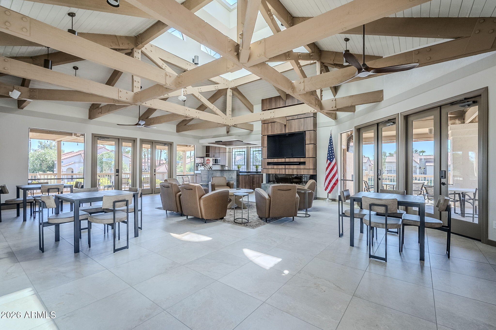 9705 East Mountain View Road, Unit 1036 Scottsdale, AZ 85258 - Photo 45 of 50 a dining hall with lots of furniture and a flat screen tv