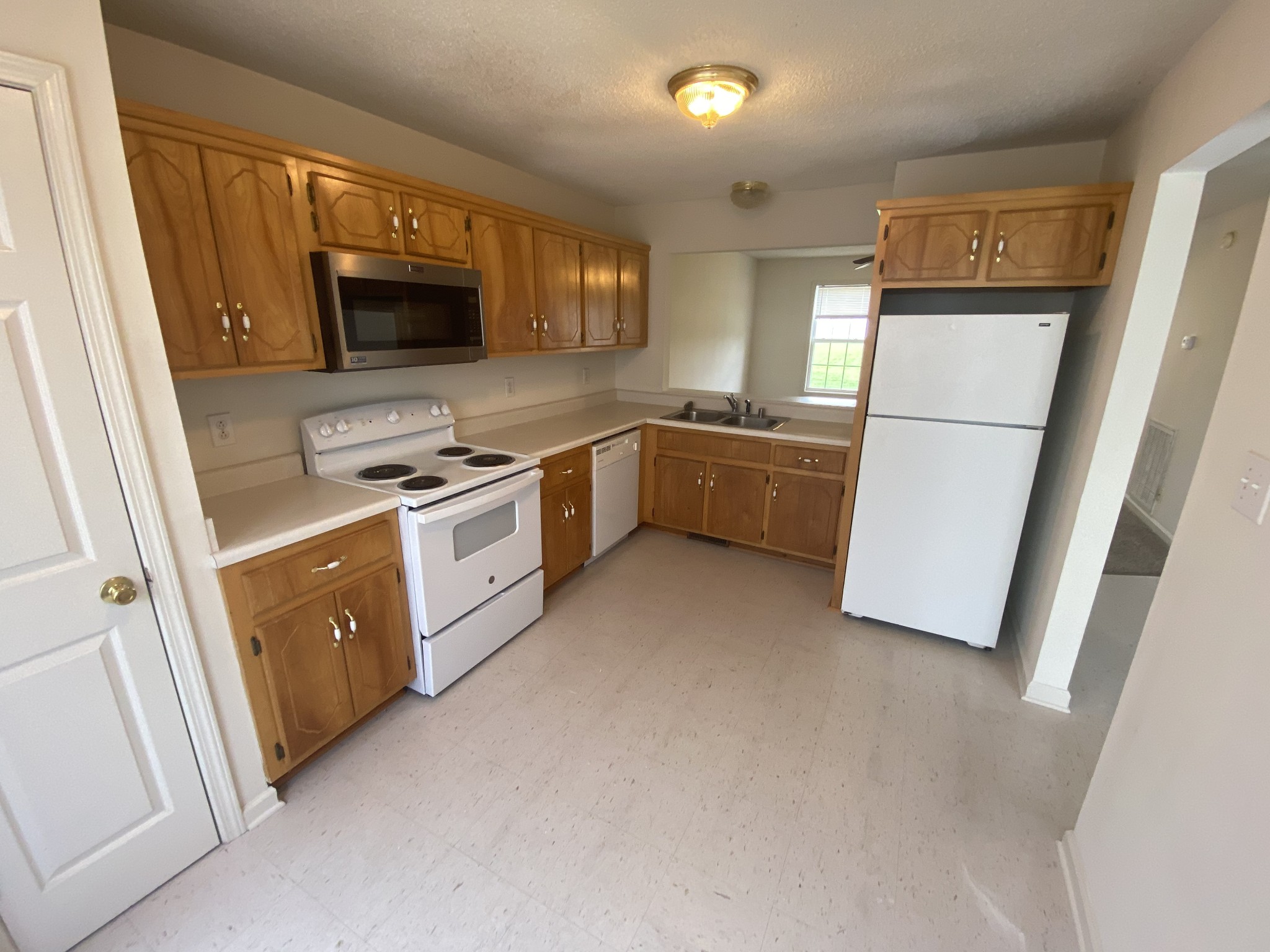 237 Tree Line Drive Oak Grove, KY 42262 - Photo 4 of 13 a kitchen with a refrigerator a microwave a sink and cabinets