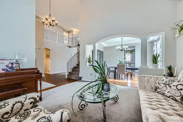 a living room with furniture and a chandelier
