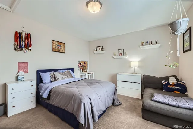 a spacious bedroom with a bed and a couch