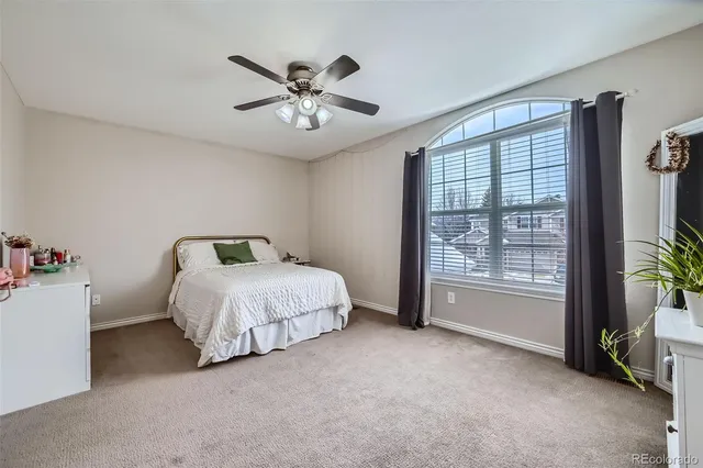 a spacious bedroom with a bed and a chandelier