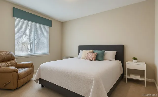 a bedroom with a bed and a couch