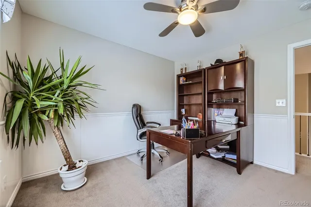 a view of a workspace with furniture and a potted plant