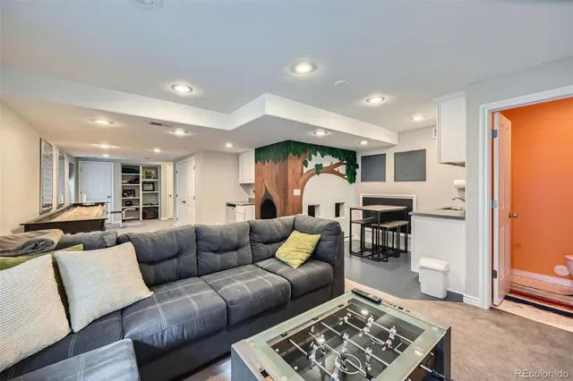 a living room with furniture and kitchen view
