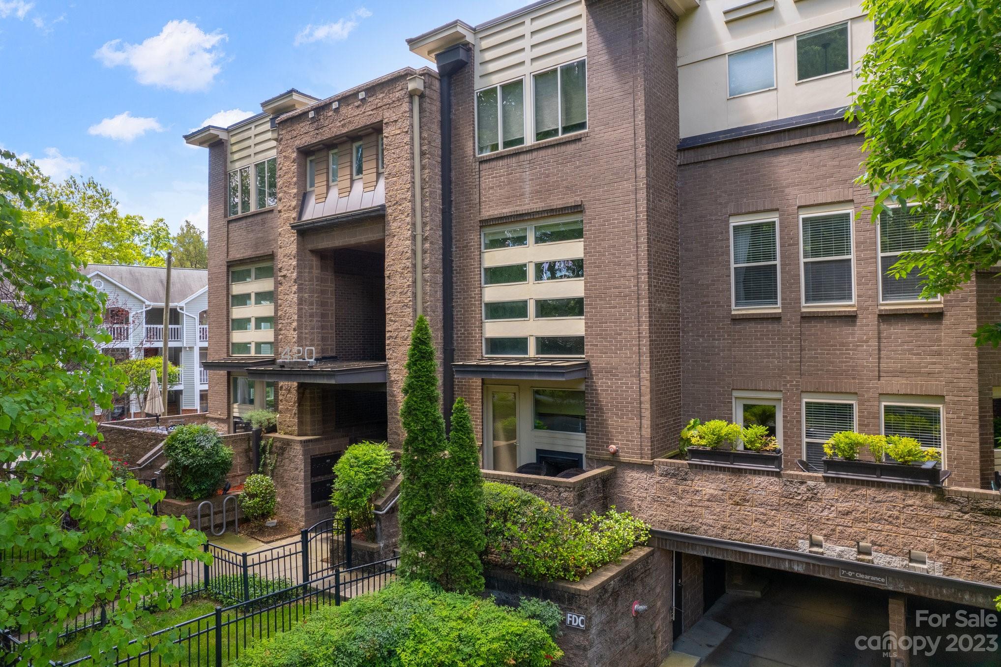 a view of an house with backyard and sitting area