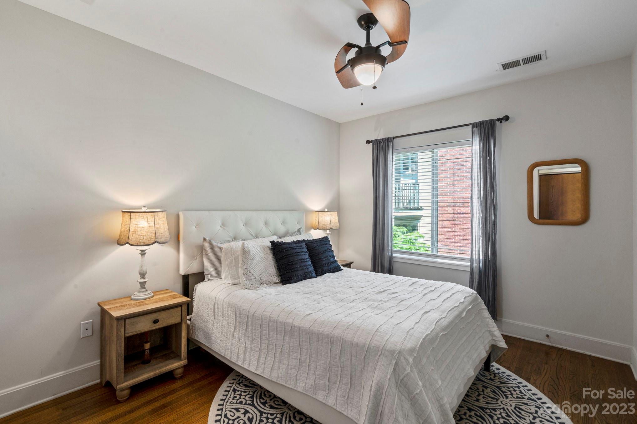 420 Queens Road, Unit 3 Charlotte, NC 28207 - Photo 13 of 35 a bedroom with a bed and wooden floor