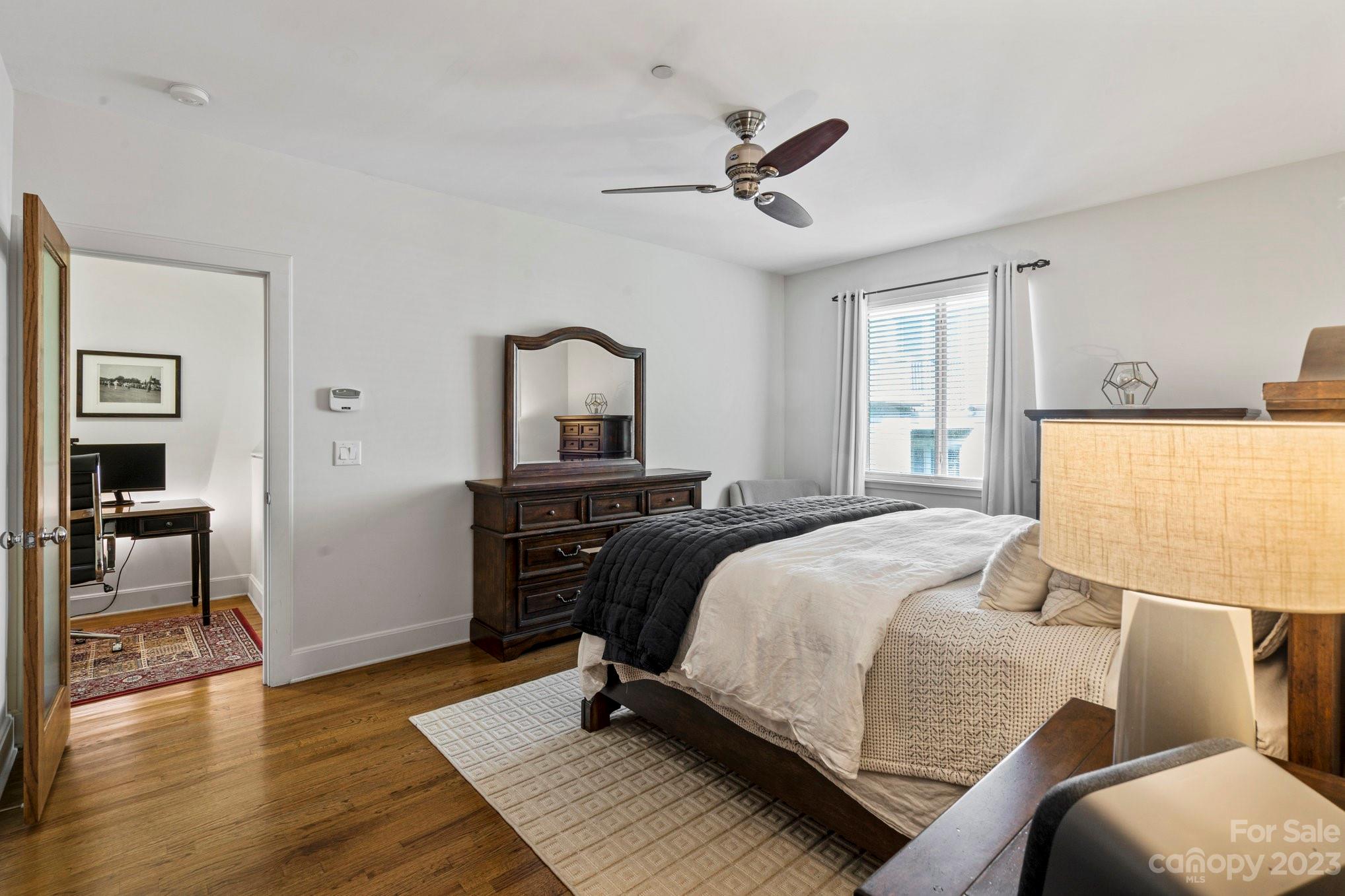 420 Queens Road, Unit 3 Charlotte, NC 28207 - Photo 22 of 35 a bedroom with a bed and wooden floor