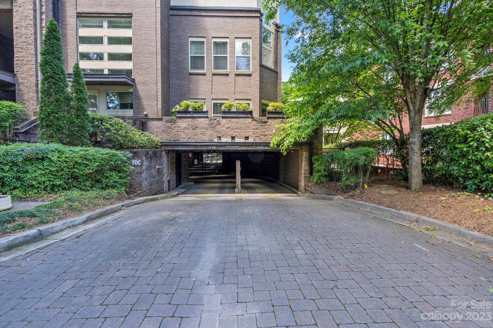 420 Queens Road, Unit 3 Charlotte, NC 28207 - Photo 27 of 35 a view of a house with brick wall and plants