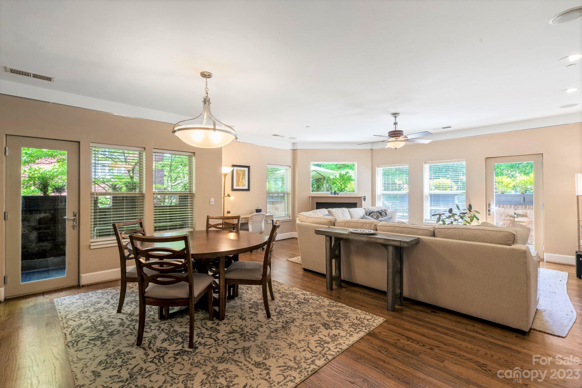420 Queens Road, Unit 3 Charlotte, NC 28207 - Photo 3 of 35 a dining room with furniture a chandelier and wooden floor
