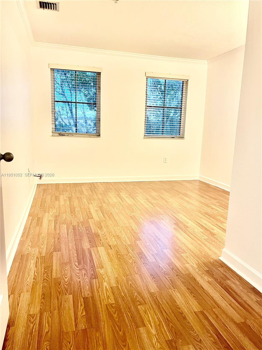 4321 Southwest 160th Avenue, Unit 202 Miramar, FL 33027 - Photo 12 of 18 a view of a room with wooden floor and a rug