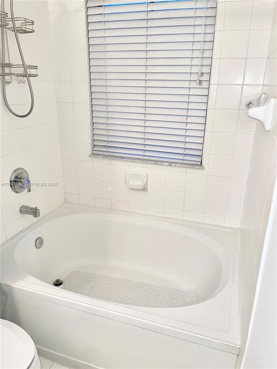 4321 Southwest 160th Avenue, Unit 202 Miramar, FL 33027 - Photo 16 of 18 a white bath tub sitting next to a white sink