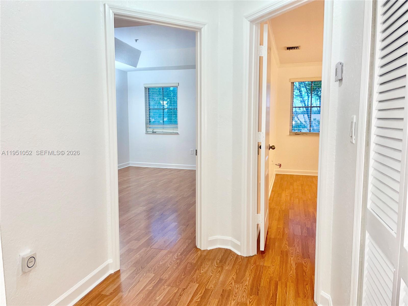 4321 Southwest 160th Avenue, Unit 202 Miramar, FL 33027 - Photo 8 of 18 a view of a hallway with wooden floor and closet