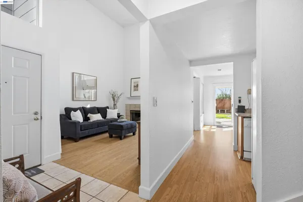 a dining hall with stainless steel appliances granite countertop a dining table and chairs with wooden floor