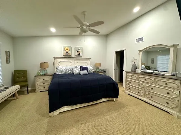 a bedroom with a bed and a large mirror