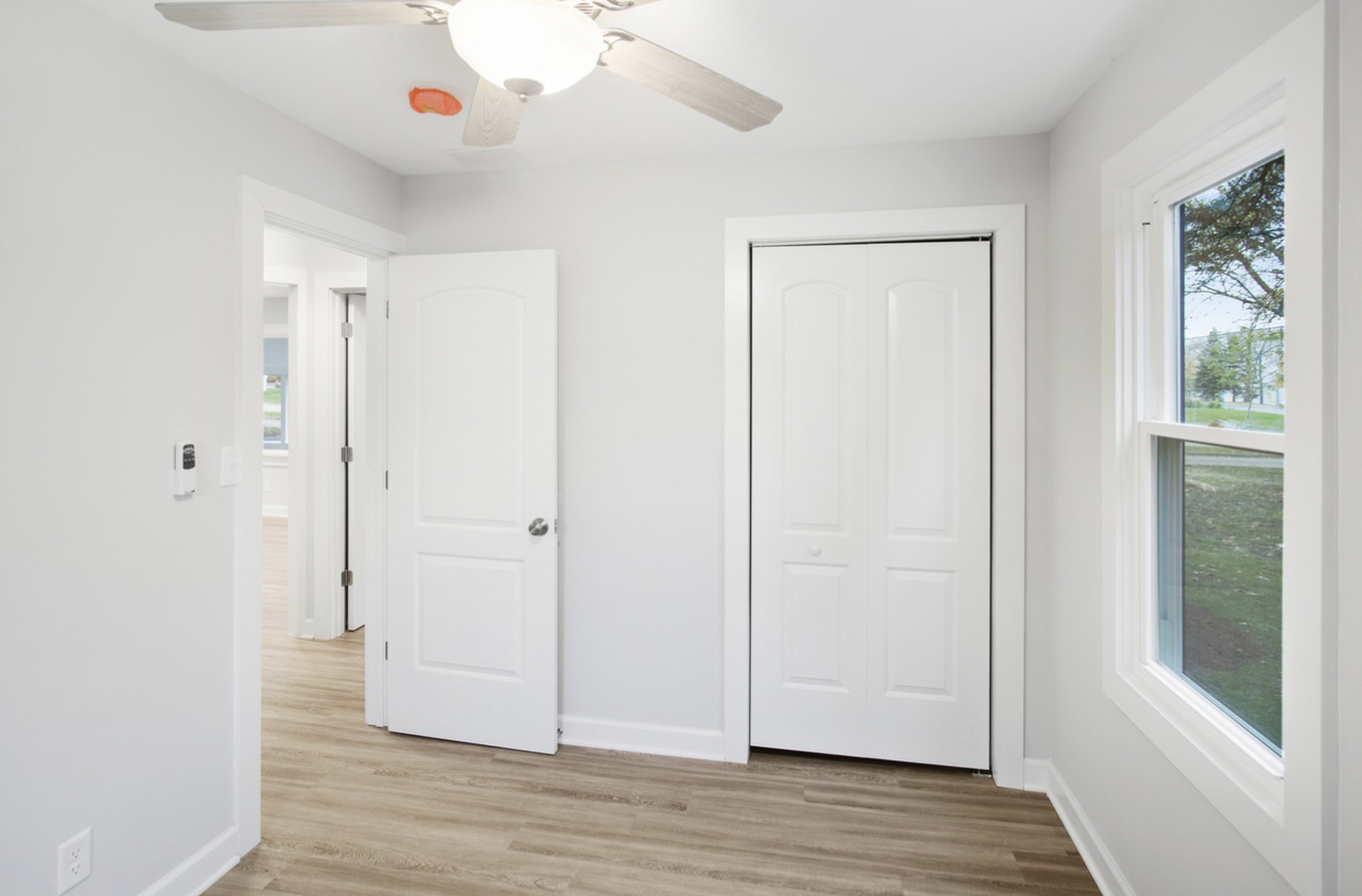 715 Anthony Trail Northbrook, IL 60062 - Photo 13 of 20 a view of an empty room with wooden floor and a window