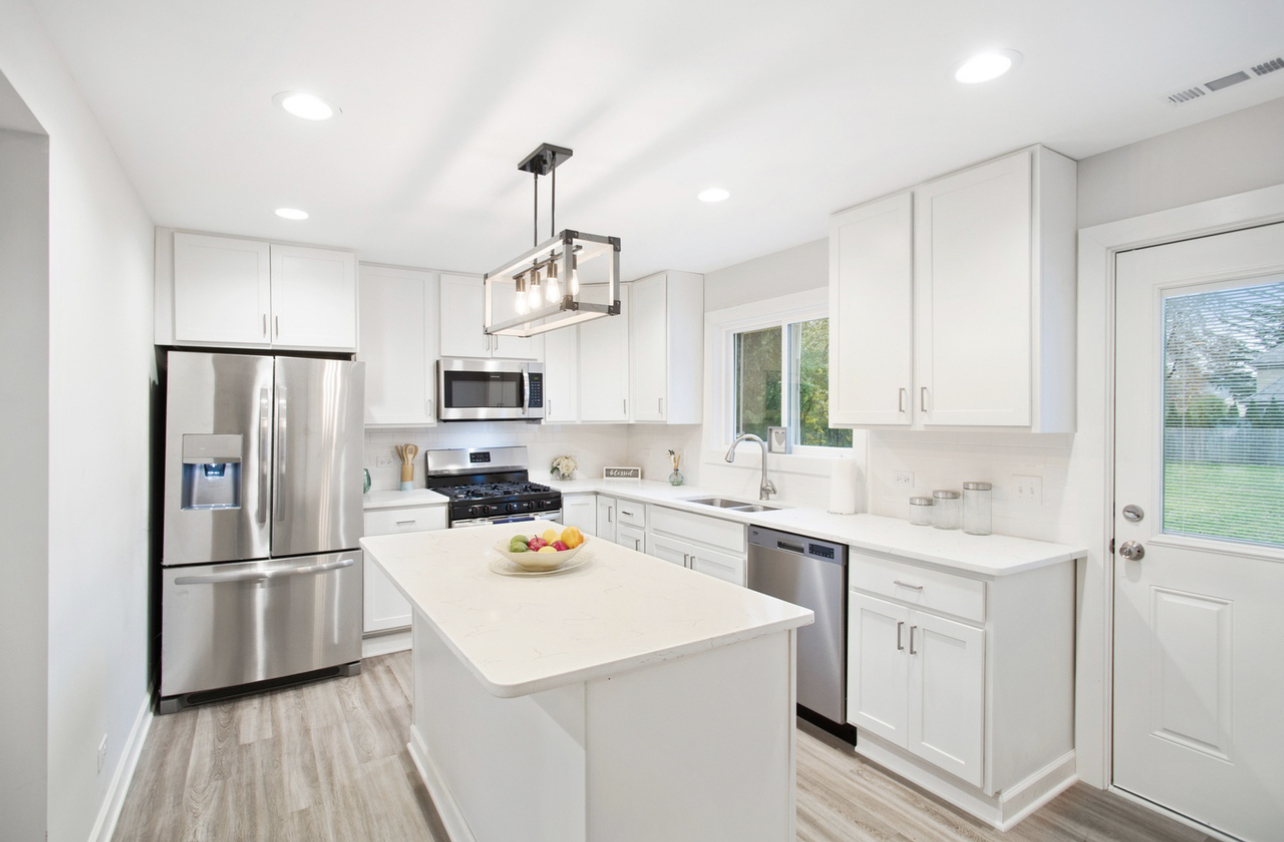 715 Anthony Trail Northbrook, IL 60062 - Photo 2 of 20 a kitchen with white cabinets and stainless steel appliances