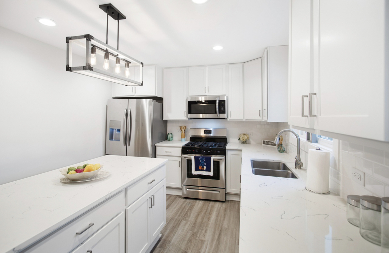 715 Anthony Trail Northbrook, IL 60062 - Photo 3 of 20 a kitchen with stainless steel appliances a sink stove refrigerator and cabinets