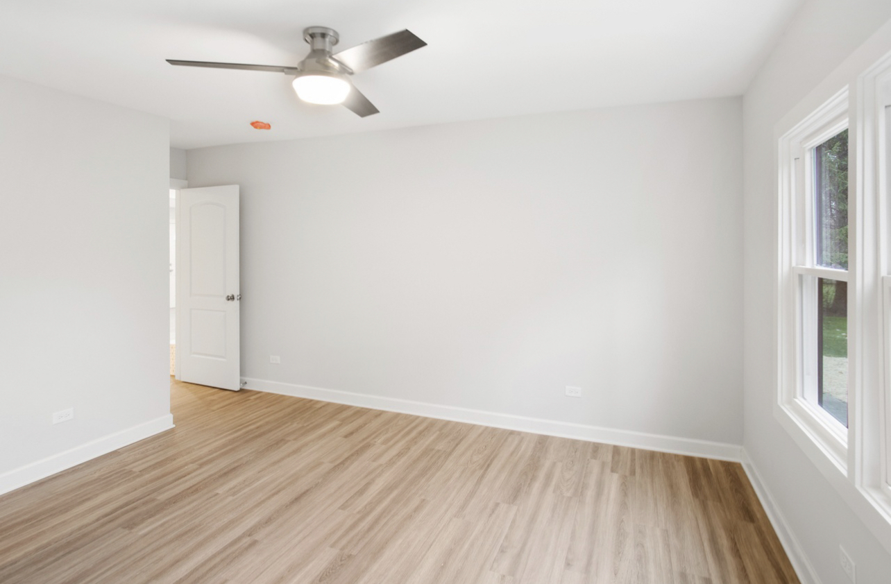 715 Anthony Trail Northbrook, IL 60062 - Photo 8 of 20 wooden floor in an empty room with a window