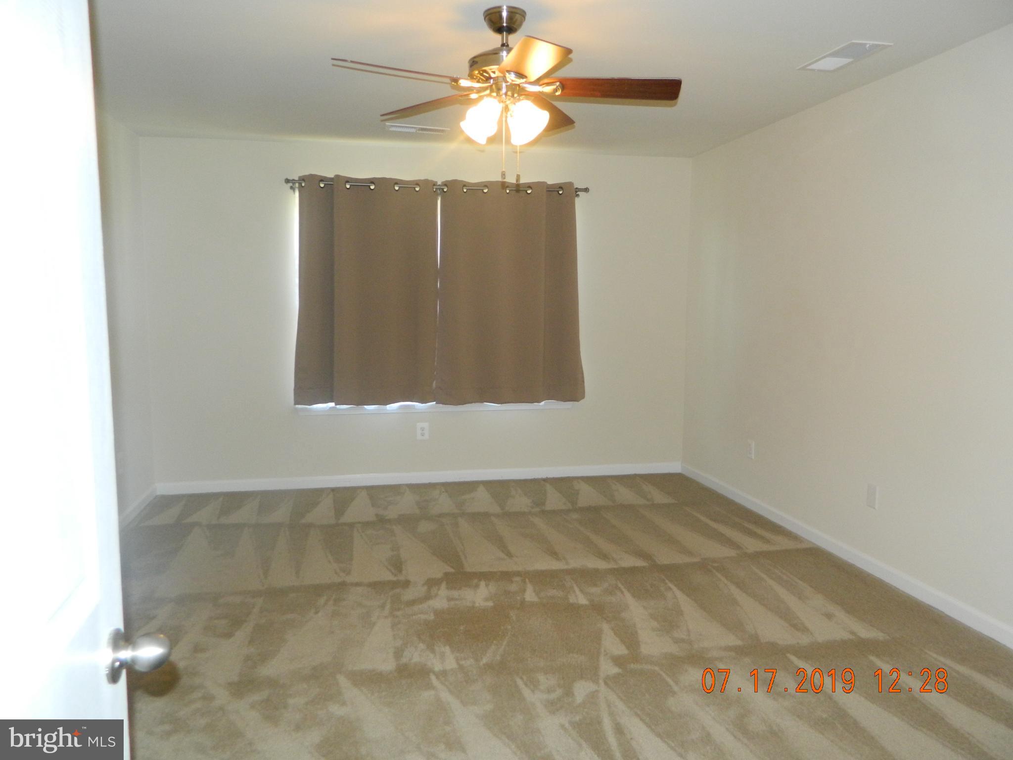 24 Baltic Lane Ranson, WV 25438 - Photo 19 of 35 Master bedroom with ceiling fan and walk in closet